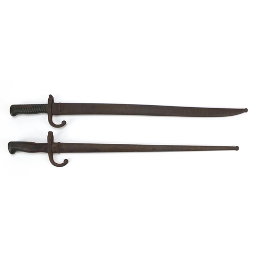 234 - Two French Military long bayonets with scabbards,  both with impressed marks, the largest 71.5cm in ... 