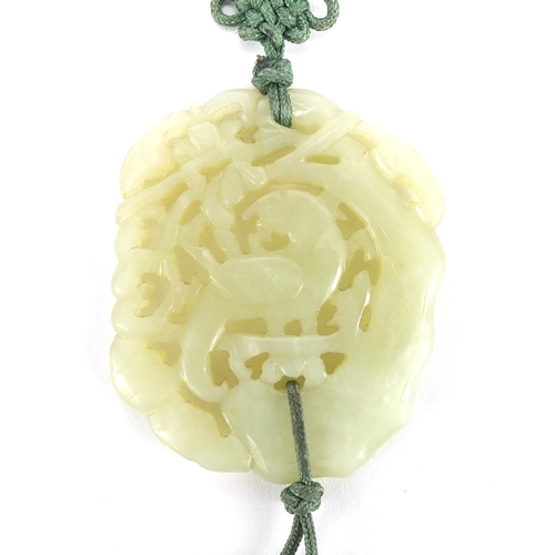 341 - Chinese green jade pendant carved with a bird of paradise on necklace, the pendant 6cm x 5cm