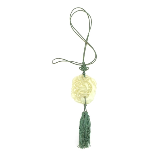 341 - Chinese green jade pendant carved with a bird of paradise on necklace, the pendant 6cm x 5cm