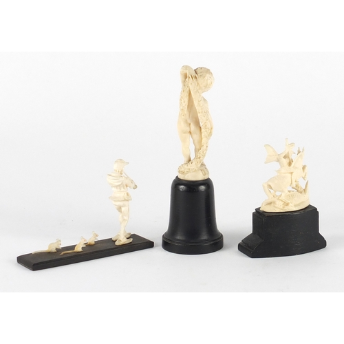 58 - Three ivory carvings comprising a Dieppe nude boy, the Pied Piper and St George and the dragon, each... 