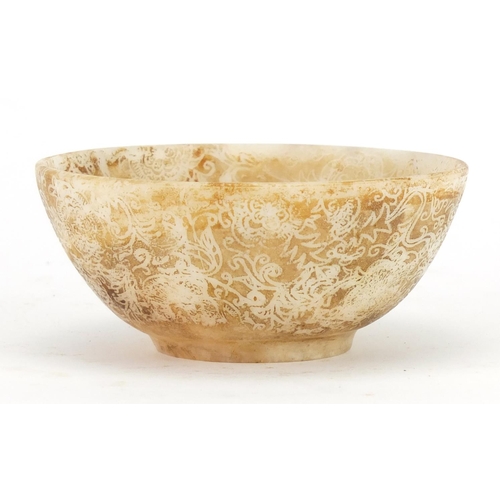 2364 - Middle Eastern hardstone bowl decorated with stylised flowers, 11cm in diameter