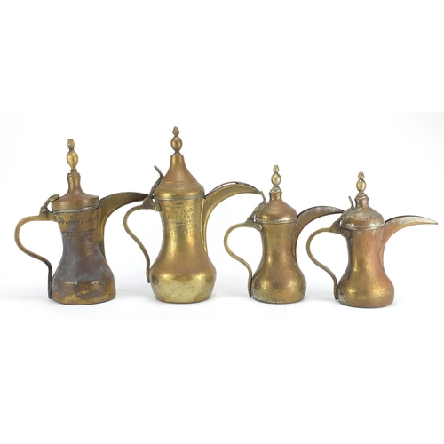 2328 - Four Middle Eastern coffee pots, some with engraved decoration, the largest 37cm high