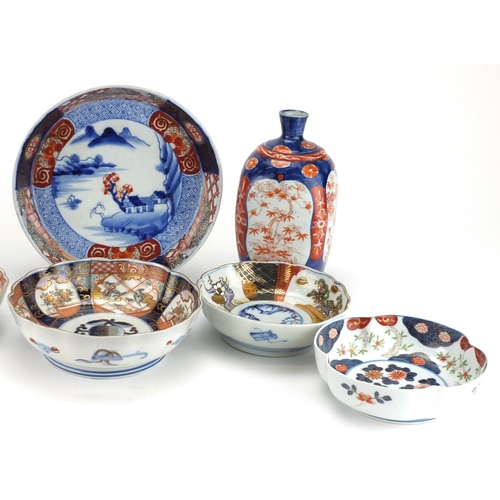 2351 - Japanese porcelain including a pair of vases with square bodies and Imari pattern bowls, one hand pa... 