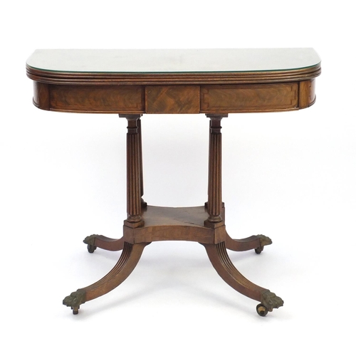 2002 - Regency inlaid walnut fold over card table, raised with quadruple fluted columns with brass paw feet... 