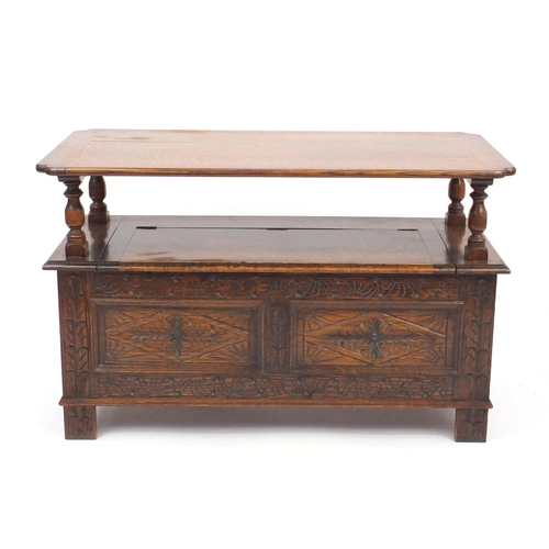 2043 - Carved oak monks bench with lift up storage seat and T. C. Harwood label to the back, 68.5cm H x 106... 