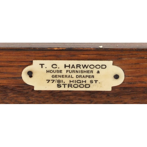 2043 - Carved oak monks bench with lift up storage seat and T. C. Harwood label to the back, 68.5cm H x 106... 