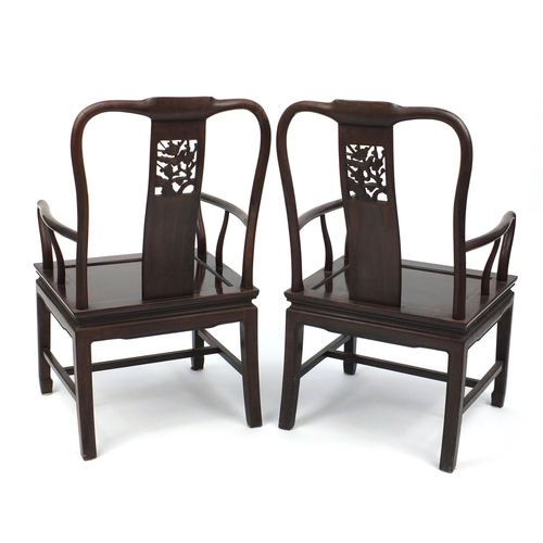 2077 - Pair of Chinese hardwood open armchairs carved with prunus flowers, each 96.5cm high