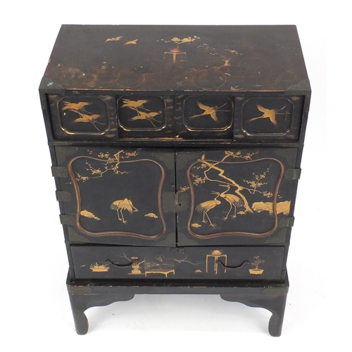 2014 - Black lacquered chinoiserie cabinet on stand, fitted with two pairs of sliding doors above a pair of... 