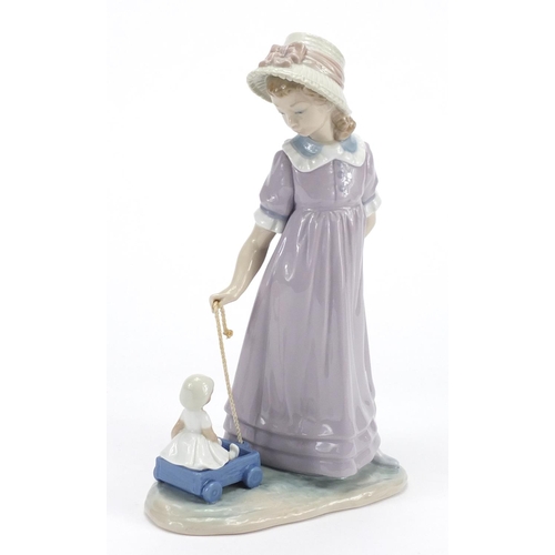 2155 - Lladro figurine of a girl pulling a cart with a doll, 27.5cm high