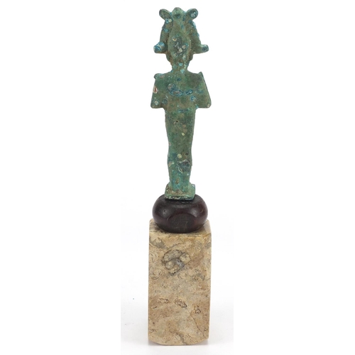 2304 - Egyptian bronze figure of Osiris raised on a polished stone base, 29.5cm high