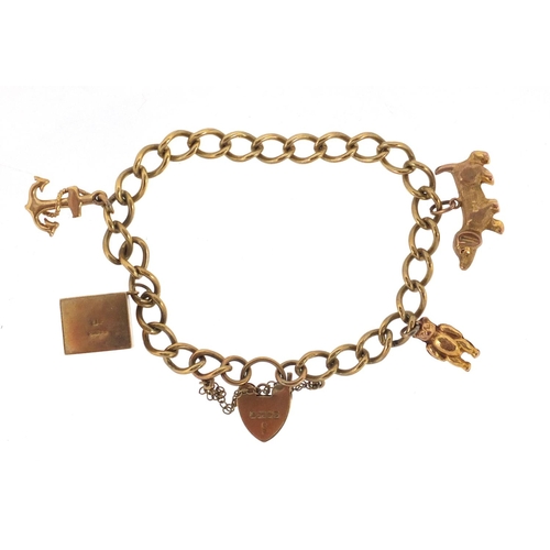 2626 - 9ct old charm bracelet with gold charms including an emergency ten shilling note, Dachshund dog and ... 