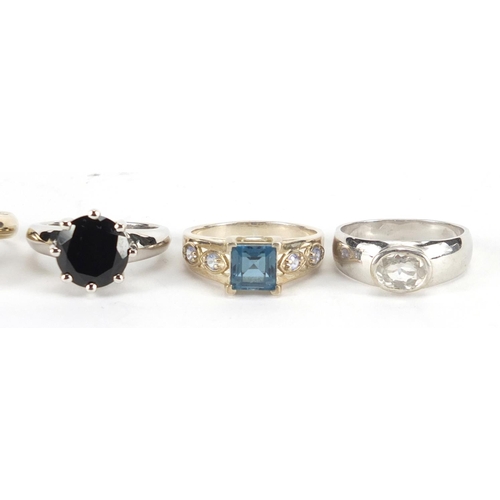 2870 - Five silver rings set with semi precious stones including white zircon, topaz, black diamond and tan... 