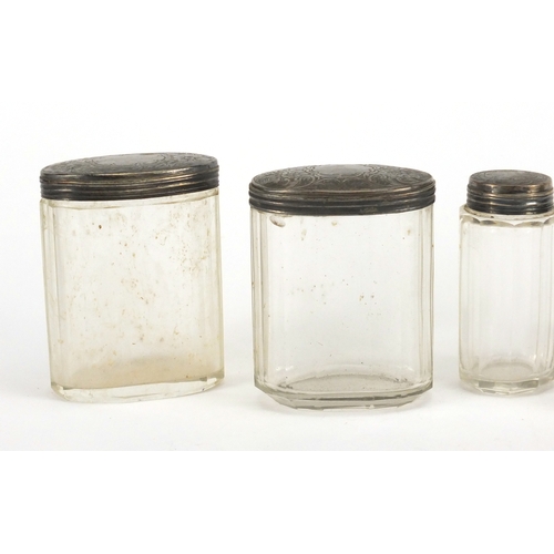 2603 - Five cut glass jars and bottles with silver lids, four by W G Birmingham, the largest 9.5cm high