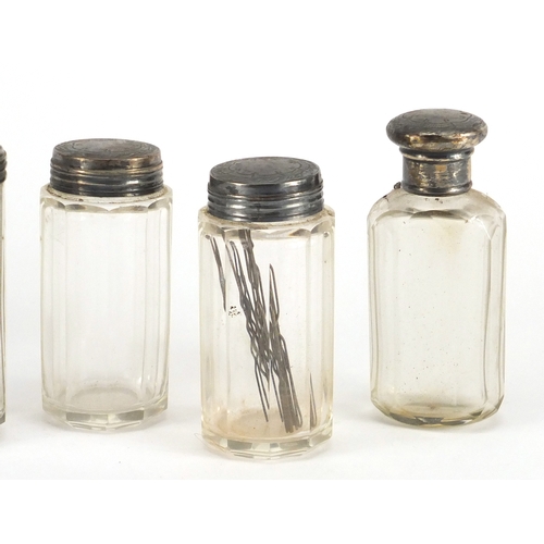 2603 - Five cut glass jars and bottles with silver lids, four by W G Birmingham, the largest 9.5cm high