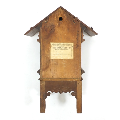 2342 - Carved walnut cuckoo clock with Roman numerals and Camerer Cuss Co label to the reverse, 58cm high