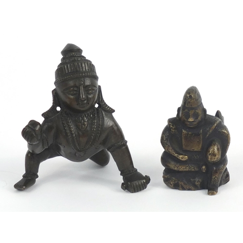 462 - Two Middle Eastern bronzed metal figures, the largest 7.5cm high