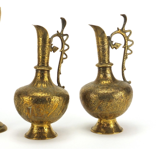 411 - Pair of Middle Eastern brass jugs and vases, engraved with animals and flowers, the largest 25cm hig... 