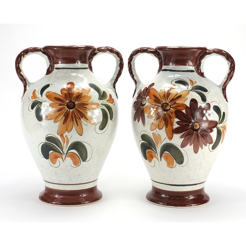 98 - Pair of Italian pottery twin handled vases, hand painted with flowers, 40cm high
