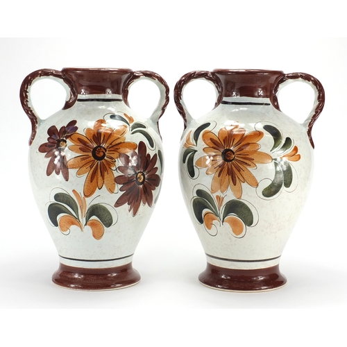 98 - Pair of Italian pottery twin handled vases, hand painted with flowers, 40cm high