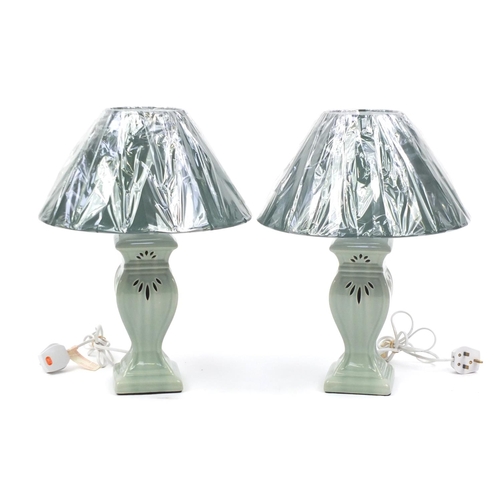 145 - Pair of green celadon glazed table lamps, with shades, 48cm high