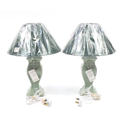 145 - Pair of green celadon glazed table lamps, with shades, 48cm high