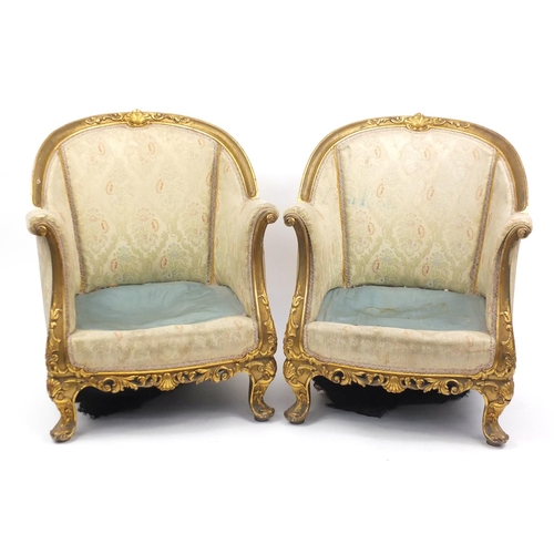 24 - Pair of French gilt wood tub chairs, with scroll arms, shell carved knees and floral upholstery, 81c... 