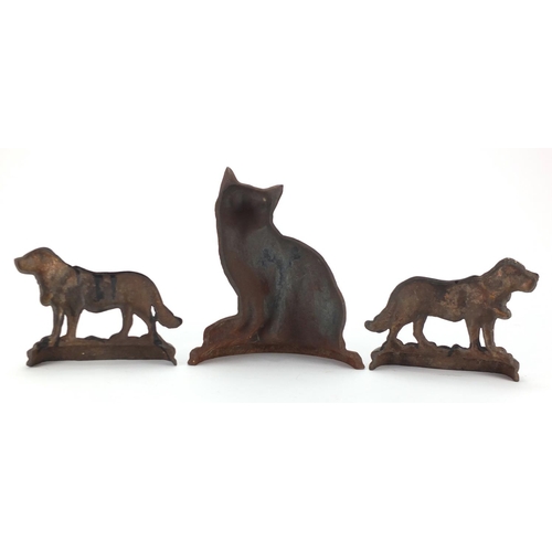 270 - Victorian style cast iron seated cat door stop and pair of St Bernard's, the largest 29cm high
