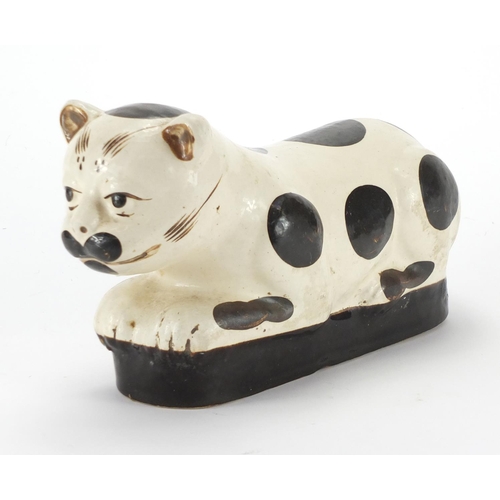 142 - Chinese pottery opium pillow in the form of a recumbent cat, 32cm in length