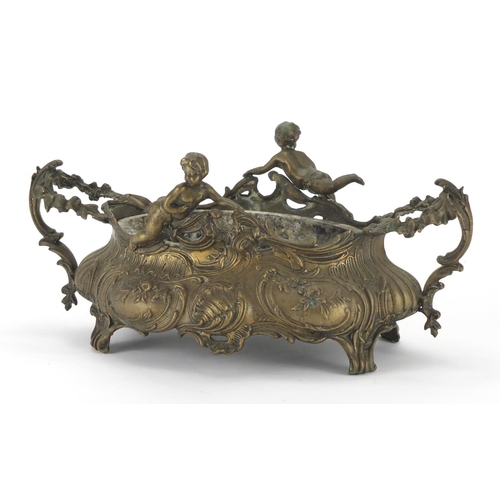201 - Art Nouveau style brass twin handled centre piece mounted with putti, 34cm wide