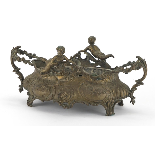 201 - Art Nouveau style brass twin handled centre piece mounted with putti, 34cm wide