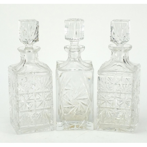 140 - Pair of cut crystal decanters with stoppers and one other, 27cm high
