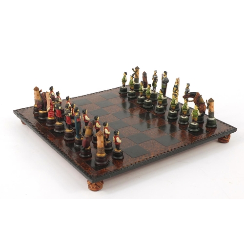 271 - Decorative resin chess set with board, 44cm square