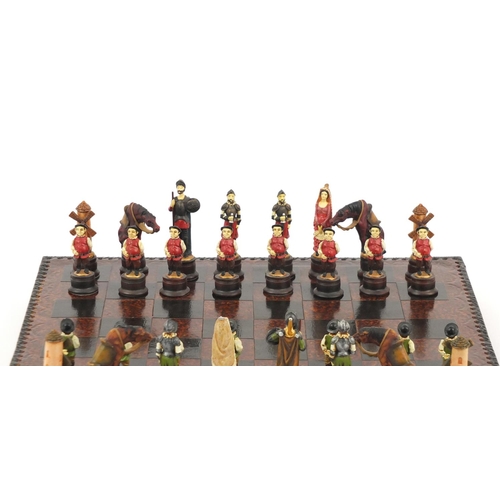 271 - Decorative resin chess set with board, 44cm square