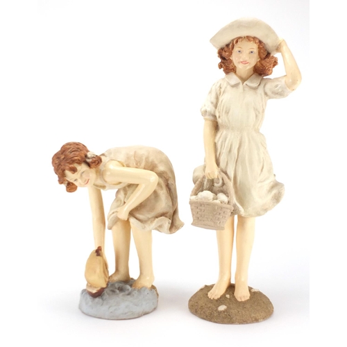 162 - Two decorative figurines of young girls at the seaside, the largest 45cm high