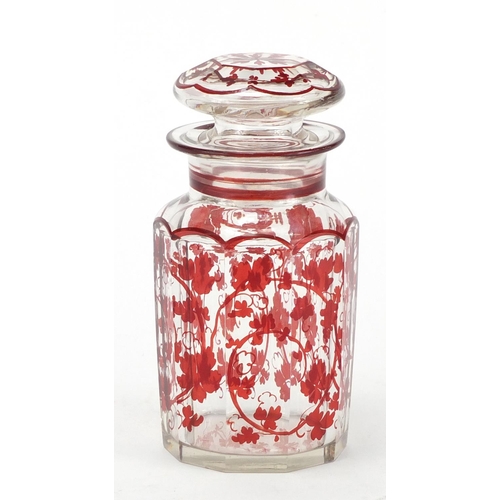 526 - Bohemian style red flashed cut glass jar and cover, 16cm high
