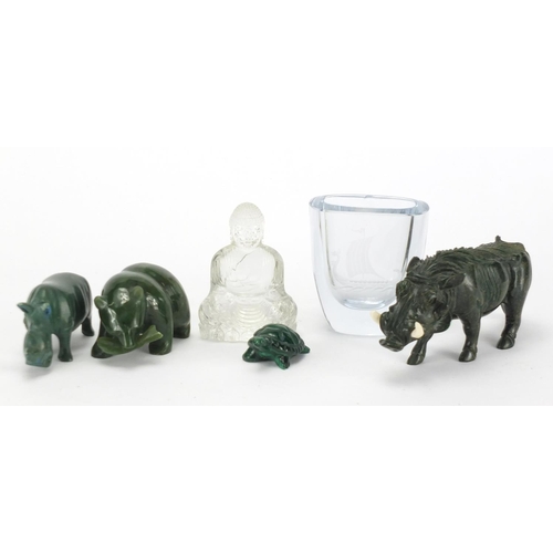738 - Four carved stone animals, an etched glass vase and glass figure of seated Buddha