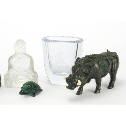 738 - Four carved stone animals, an etched glass vase and glass figure of seated Buddha