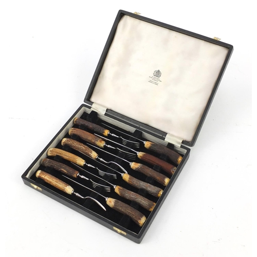 221 - Set of six horn handled knives and forks, by Mappin & Webb, housed in a fitted box