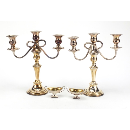 161 - Pair of silver plated three branch candelabra and pair of open salts, the candelabra 31cm high