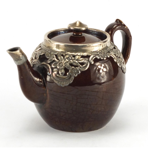 582 - Treacle glazed teapot with silver mounts, hallmarked Birmingham 1906