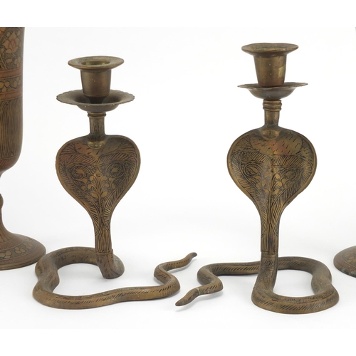 732 - Pair of Cairoware brass vases and cobra candlesticks, the vases, 26cm high