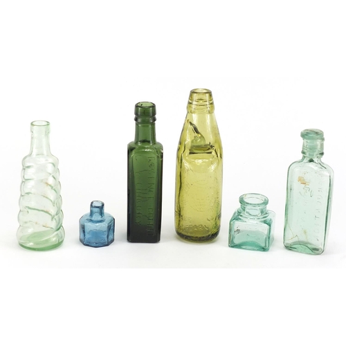 535 - Six antique glass bottles and inkwells including Ellimans Embrocation, Shieldhall Essence of Coffee ... 