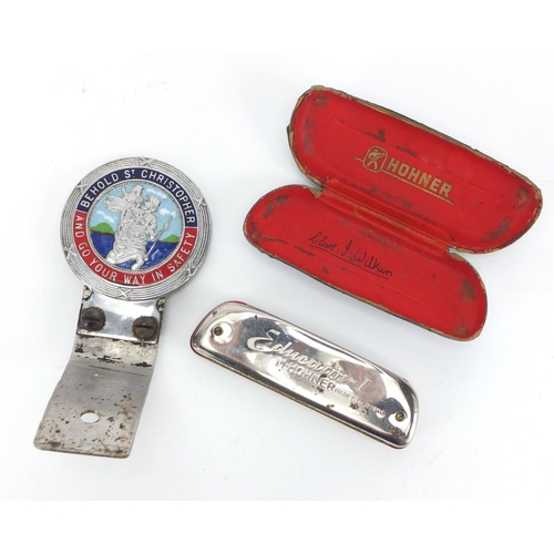 691 - Enamelled St Christopher car radiator badge and Hohner harmonica