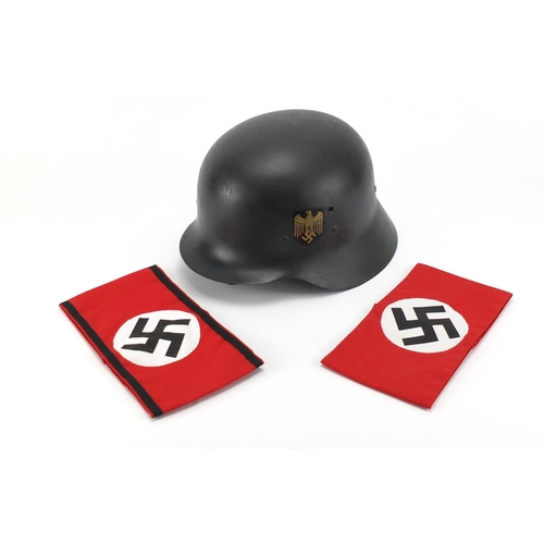 1004 - German style military interest tin helmet and two armbands