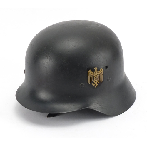 1004 - German style military interest tin helmet and two armbands