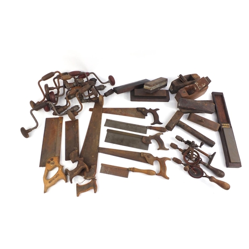 895 - Vintage hand tools including saws, drills and wood planes