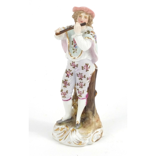 414 - 19th century German porcelain figure playing a flute, 10.5cm high