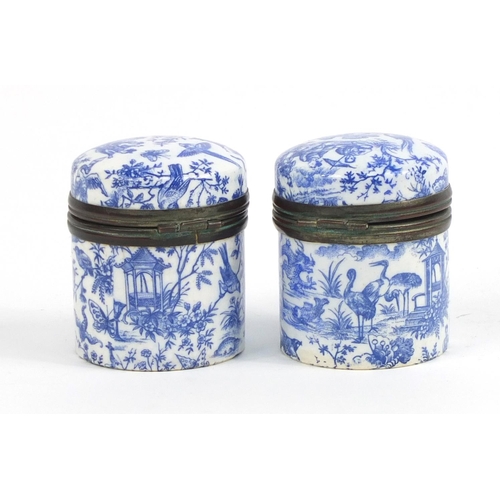 412 - Pair of Japanese blue and white porcelain jars with hinged lids, decorated with figures and birds of... 