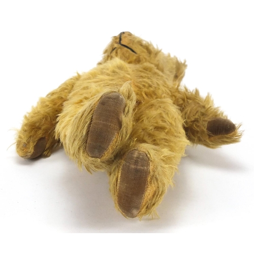 557 - Vintage golden straw filled teddy bear, with articulated limbs and glass bead eyes, 38cm high
