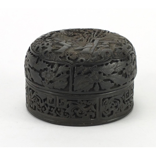 781 - Chinese horn bun shaped box and cover, carved with figures and a pagoda, 8cm in diameter